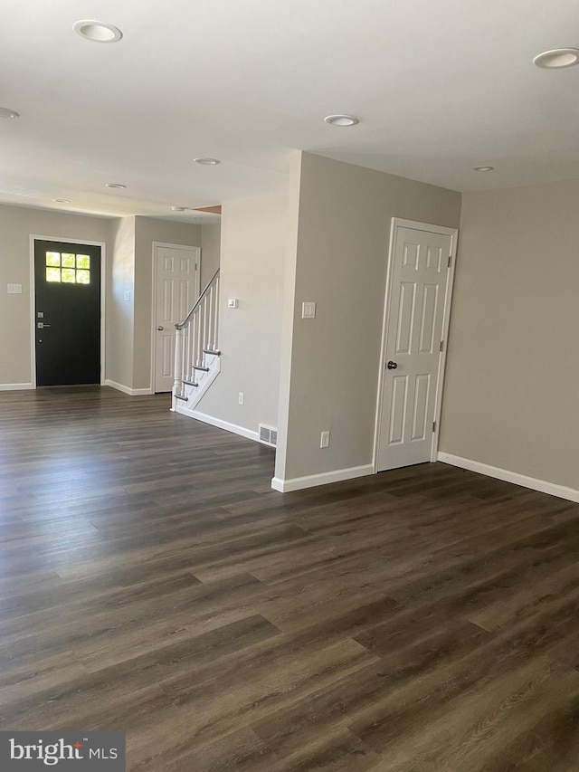 unfurnished room with dark hardwood / wood-style floors