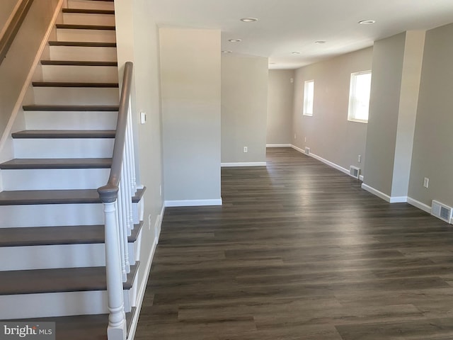 staircase with wood-type flooring