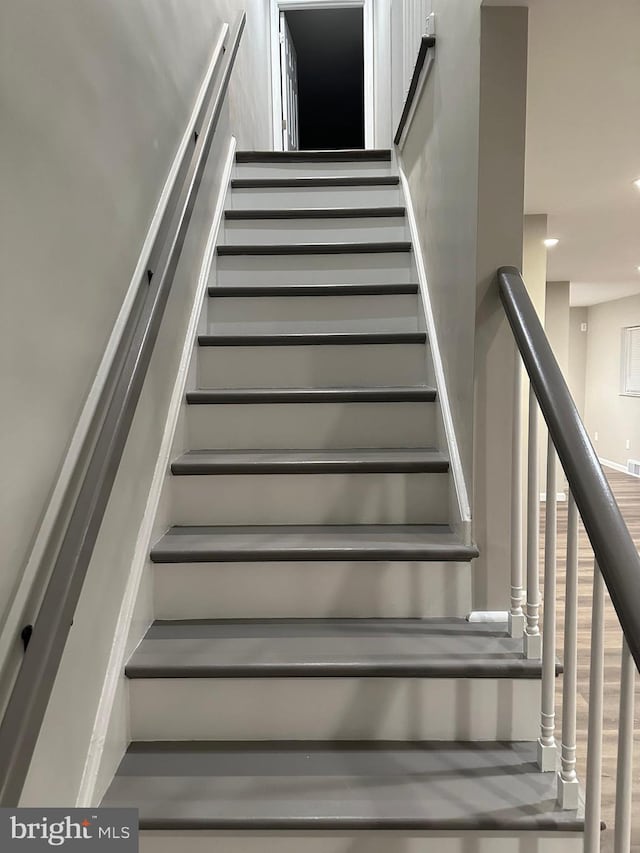 stairway featuring hardwood / wood-style floors