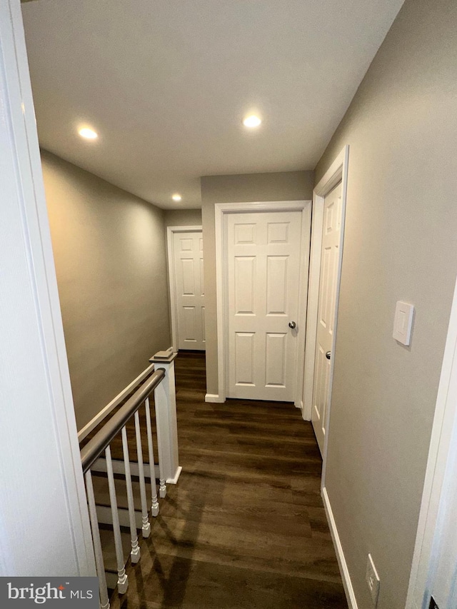 corridor with dark hardwood / wood-style floors