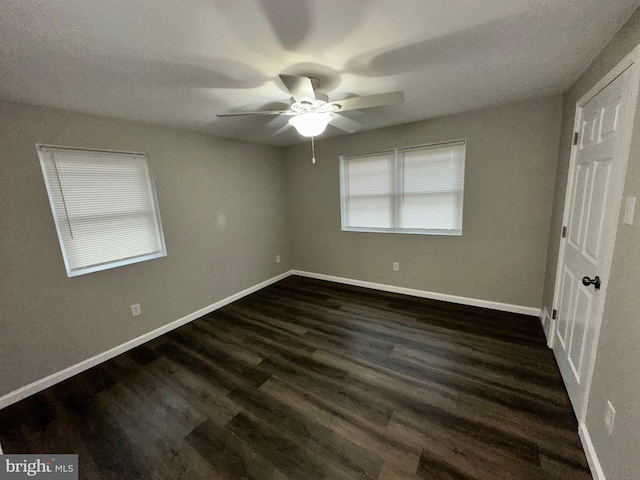 empty room featuring dark hardwood / wood-style floors and ceiling fan