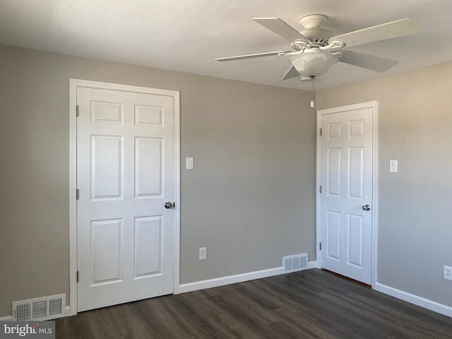 unfurnished bedroom with dark wood-type flooring and ceiling fan