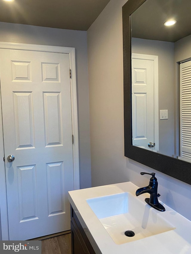 bathroom featuring vanity and wood-type flooring