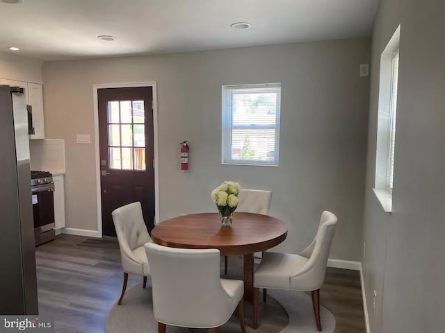 dining area with dark hardwood / wood-style floors