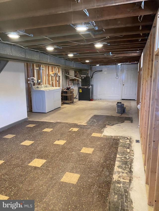 basement featuring independent washer and dryer and heating unit