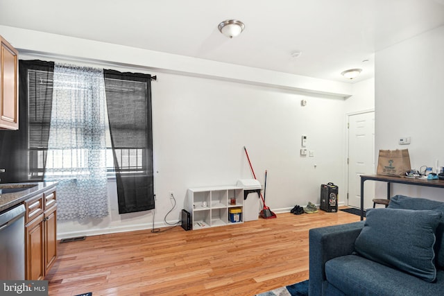 living room featuring sink and light wood-type flooring