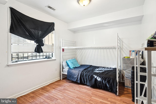 bedroom with hardwood / wood-style flooring