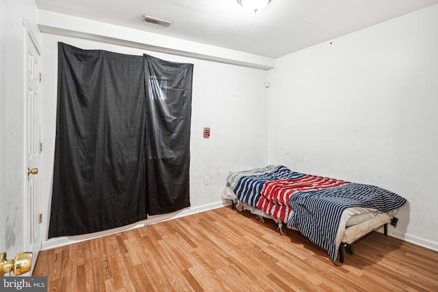 bedroom with hardwood / wood-style flooring