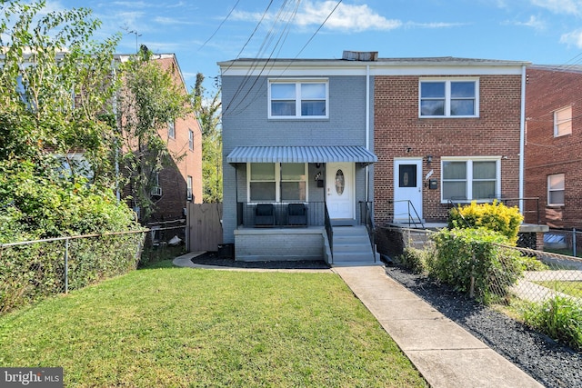 view of front of home with a porch and a front lawn