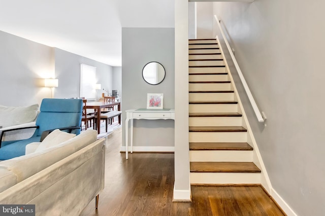 stairway with hardwood / wood-style floors