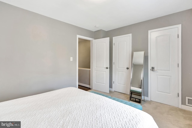 bedroom featuring light colored carpet