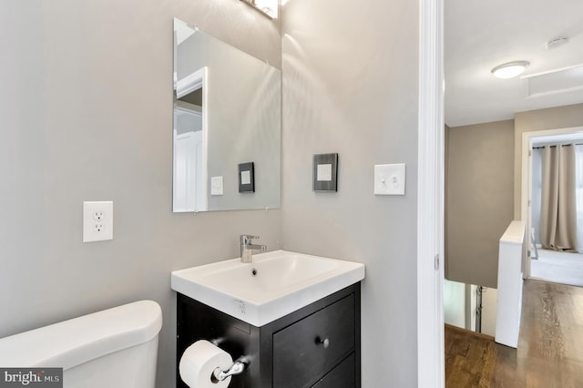 bathroom featuring vanity, hardwood / wood-style floors, and toilet