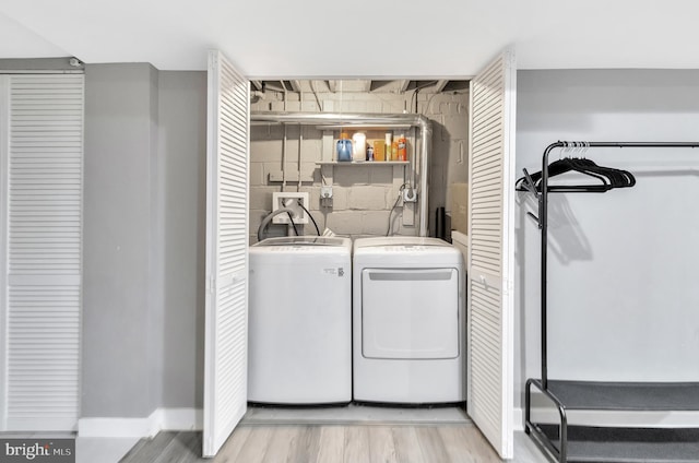 laundry area featuring independent washer and dryer and light wood-type flooring