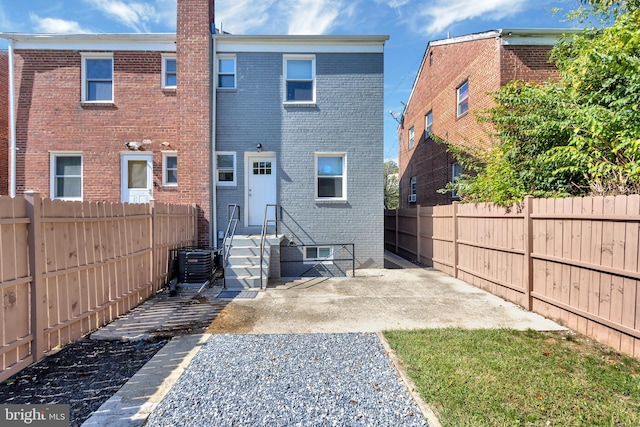 back of house with central AC unit and a patio area