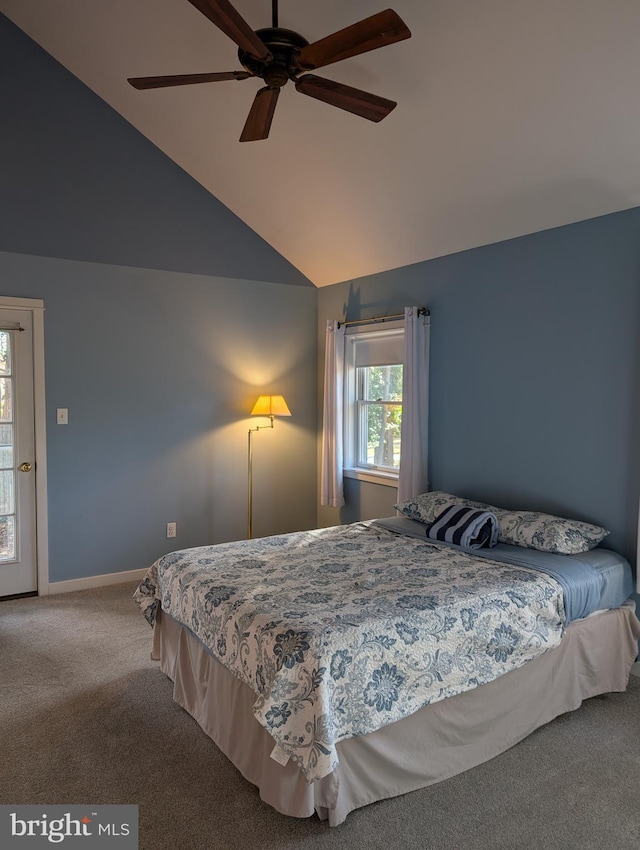 carpeted bedroom with ceiling fan and vaulted ceiling