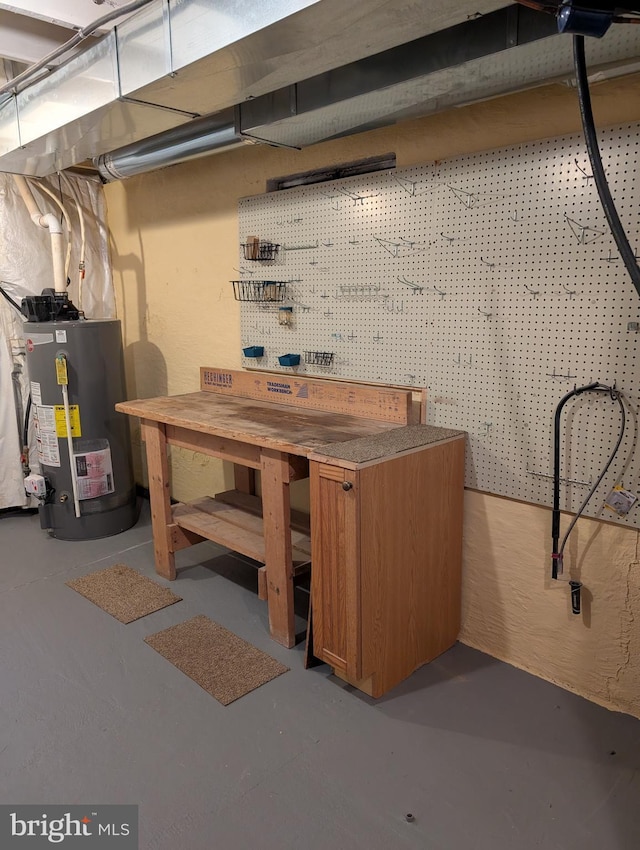 basement with gas water heater and a workshop area