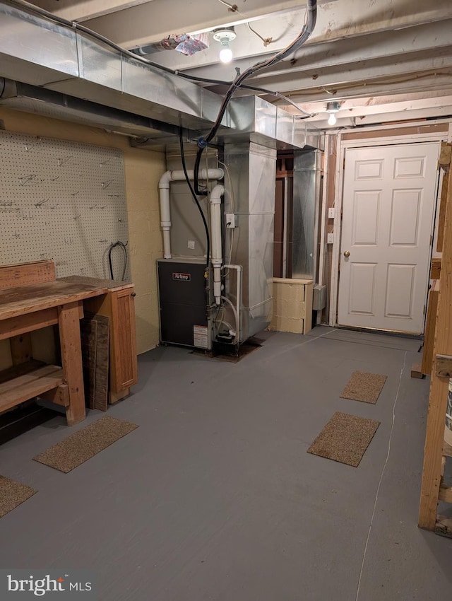 basement with heating unit and a workshop area