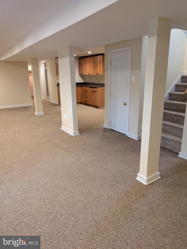 basement featuring light colored carpet