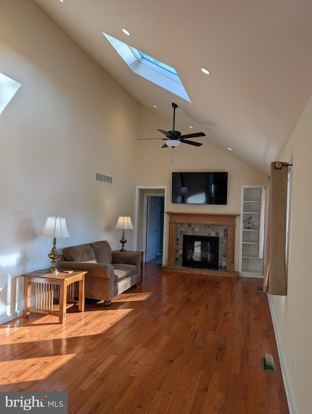 living room featuring ceiling fan, wood-type flooring, and high vaulted ceiling