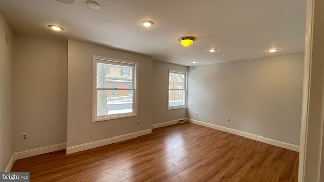 spare room with hardwood / wood-style floors