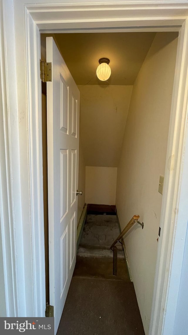 stairway featuring lofted ceiling