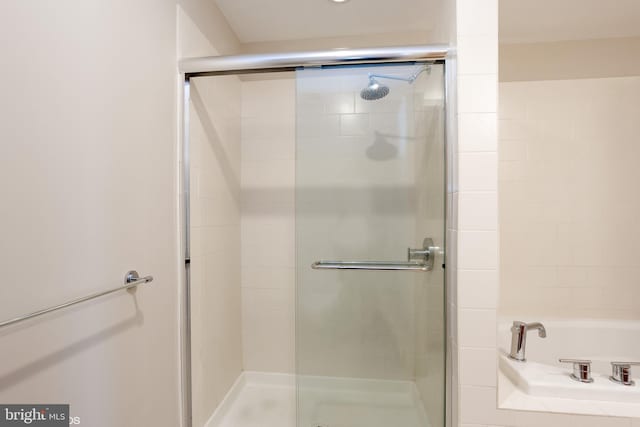 full bath featuring a shower stall and a bath