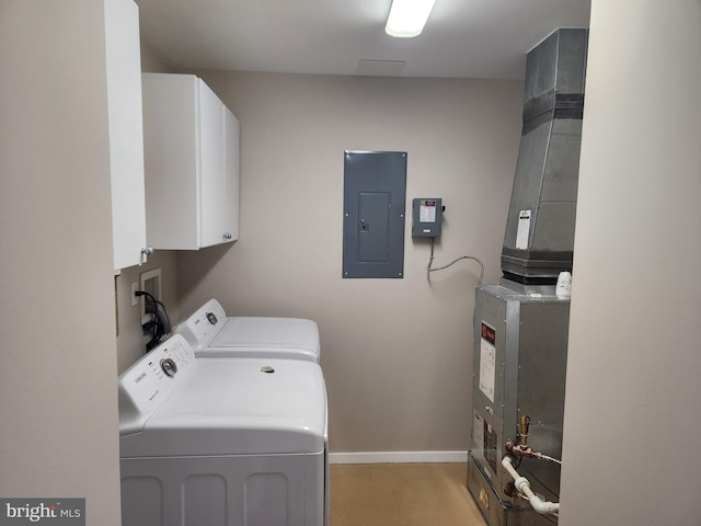 laundry room with cabinet space, electric panel, baseboards, and washer and dryer