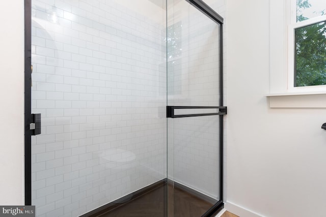 bathroom featuring a shower with door