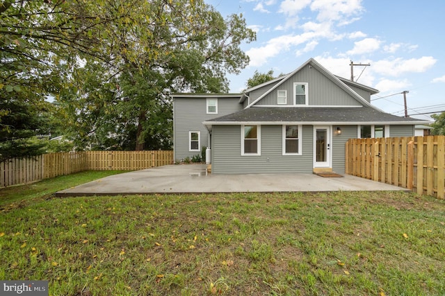 back of property featuring a yard and a patio area