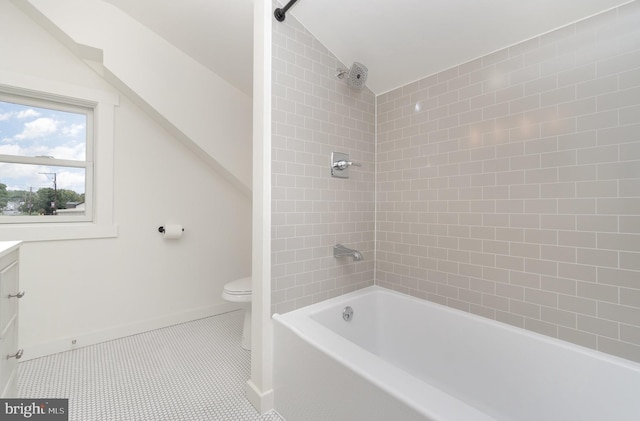 full bathroom with vaulted ceiling, tile patterned flooring, tiled shower / bath combo, vanity, and toilet