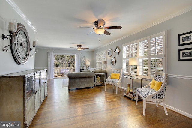 living area featuring ceiling fan, baseboards, wood finished floors, and ornamental molding