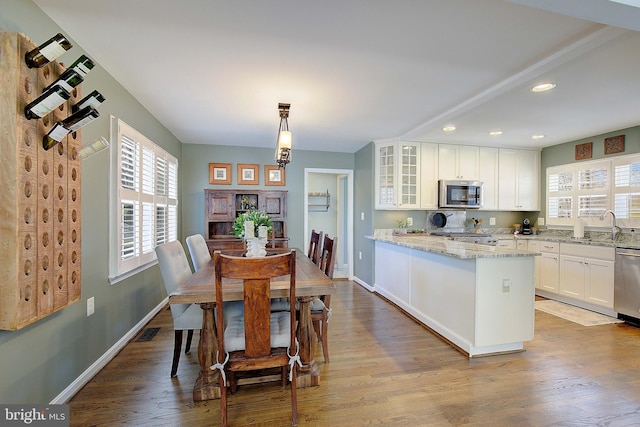 dining room featuring recessed lighting, wood finished floors, visible vents, and baseboards