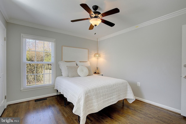 bedroom with baseboards, wood finished floors, visible vents, and ornamental molding