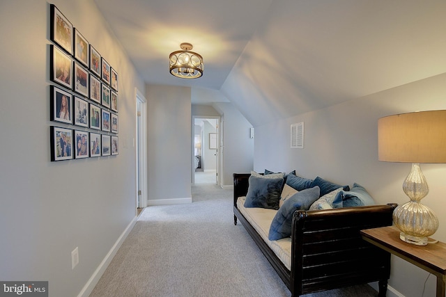 interior space with lofted ceiling, baseboards, visible vents, and a chandelier