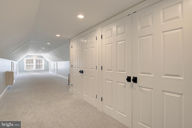 corridor with carpet flooring, recessed lighting, and lofted ceiling