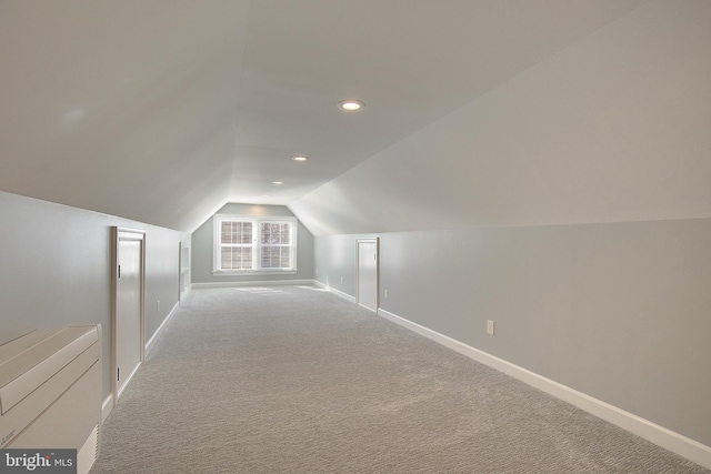 additional living space with carpet flooring, recessed lighting, baseboards, and vaulted ceiling