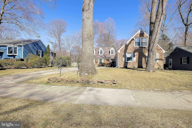 view of front facade with a front yard and brick siding