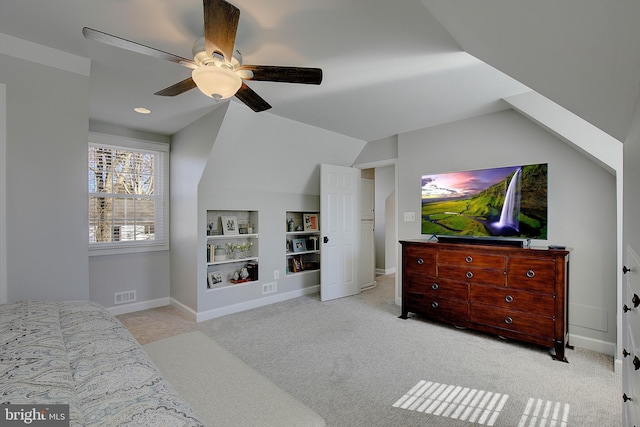 carpeted bedroom with visible vents, a ceiling fan, baseboards, and vaulted ceiling