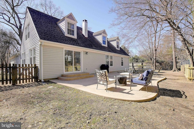 rear view of house with a patio area, a fenced backyard, a chimney, and a shingled roof