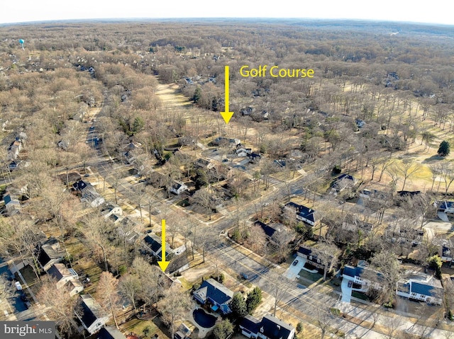 birds eye view of property featuring a wooded view