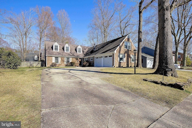 cape cod home featuring fence, driveway, a front lawn, a garage, and brick siding