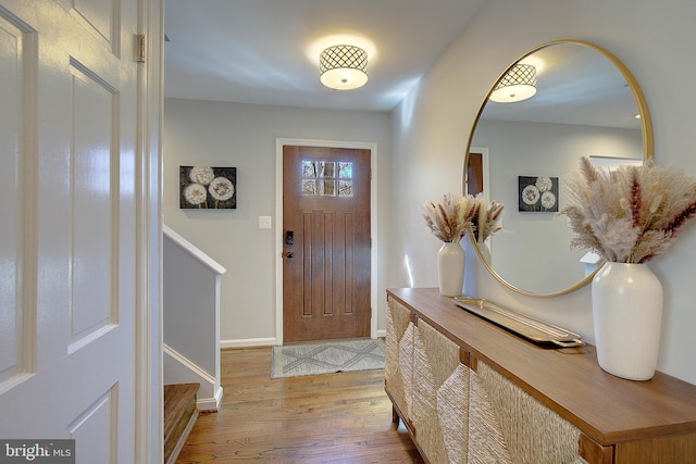 entryway with wood finished floors and baseboards