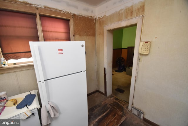 kitchen featuring visible vents and freestanding refrigerator