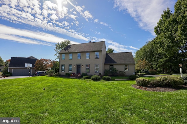 colonial-style house featuring a front yard