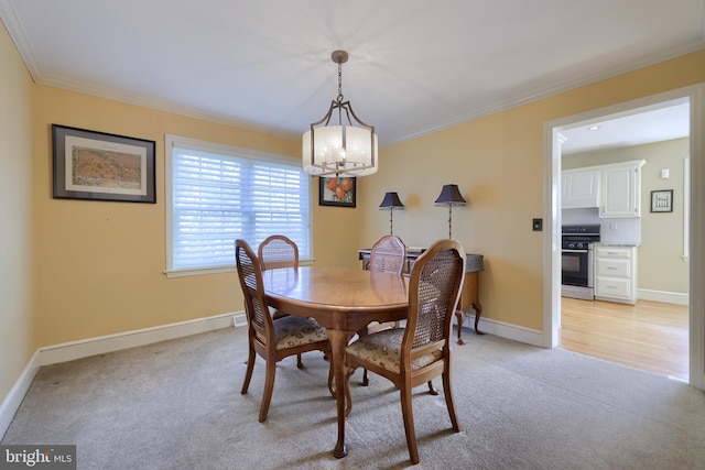 carpeted dining area with ornamental molding