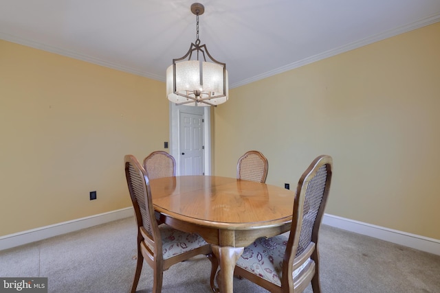 dining room with ornamental molding, carpet flooring, and a chandelier