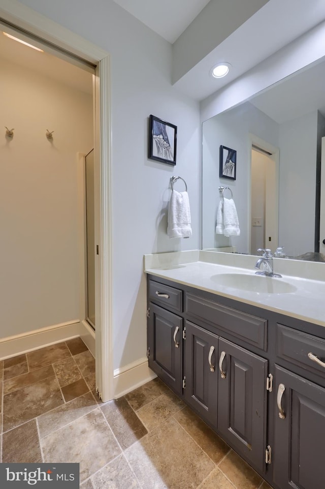 bathroom with an enclosed shower and vanity