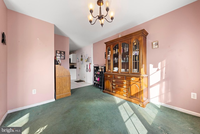 dining area featuring an inviting chandelier and dark carpet