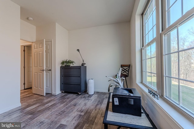 workout area with baseboards and wood finished floors