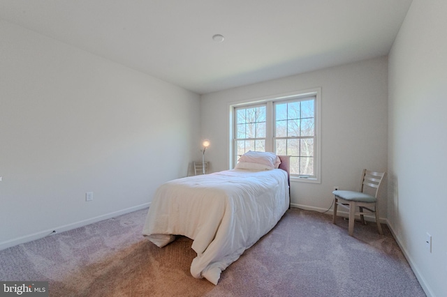 bedroom with carpet flooring and baseboards